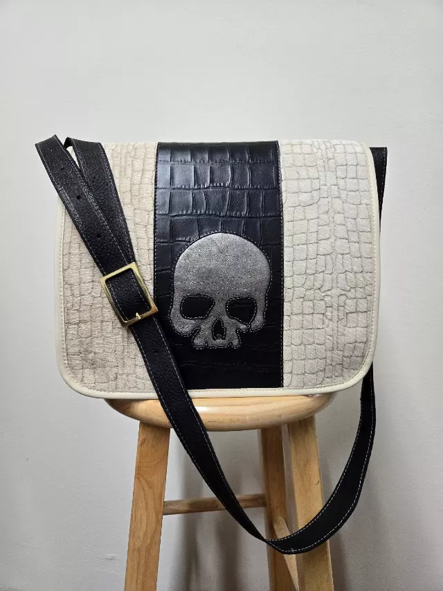 Ref 2118 — Cream embossed messenger bag with skull applique